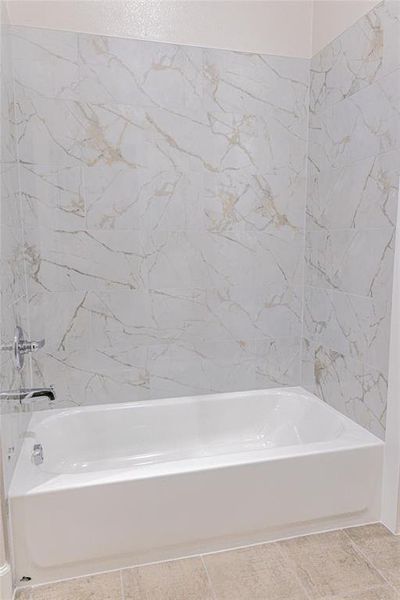 Bathroom with shower / washtub combination and light tile patterned floors Bathroom with shower / washtub combination and light tile patterned floors