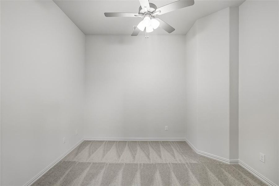 Spare room featuring light carpet and ceiling fan Spare room featuring light carpet and ceiling fan