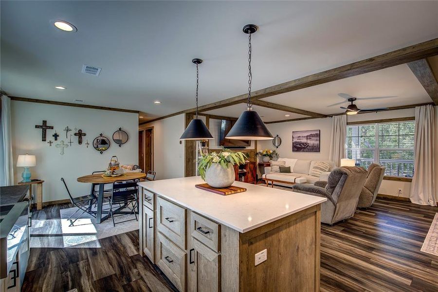 Kitchen featuring decorative light fixtures, open floor plan, a center island,  and recessed lighting