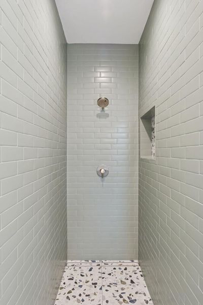 Full bath with a tile shower