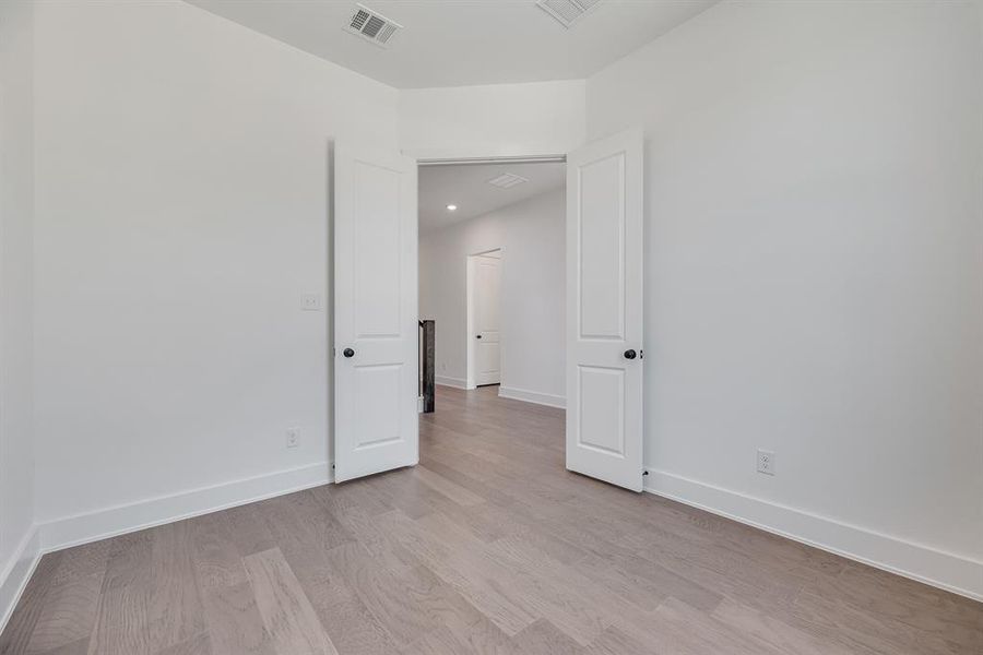 Unfurnished room with baseboards and light wood-type flooring Unfurnished room with baseboards and light wood-type flooring