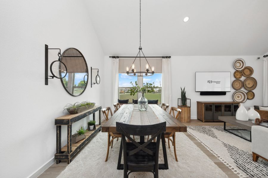 Dining area with vaulted ceiling and chandelier