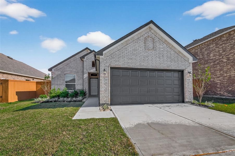 Front exterior of a new home in Lago Mar, Texas City, TX, highlighting curb appeal (Image 2). Front exterior of a new home in Lago Mar, Texas City, TX, highlighting curb appeal (Image 2).