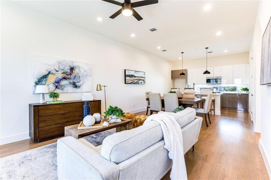 Living room featuring light wood-type flooring and ceiling fan