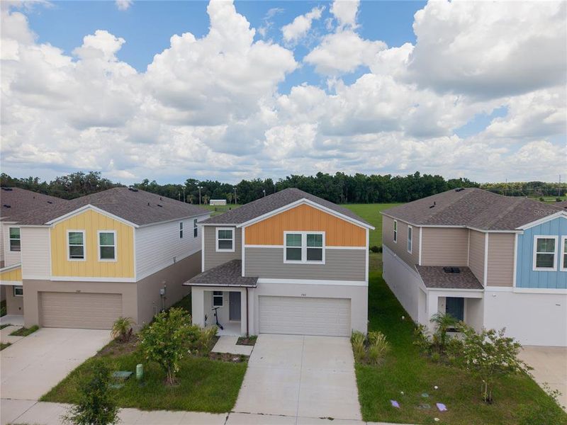 Front exterior of a new home in Pasadena Point, Wesley Chapel, FL, highlighting curb appeal (Image 22). Front exterior of a new home in Pasadena Point, Wesley Chapel, FL, highlighting curb appeal (Image 22).
