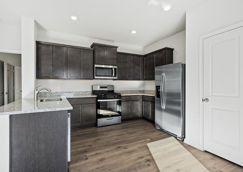 The kitchen has beautiful wood cabinets.