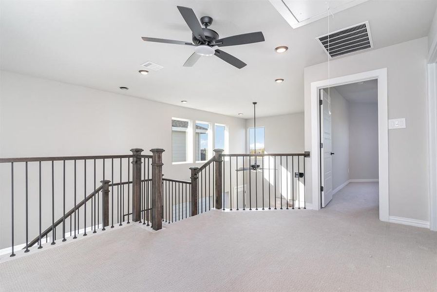 Hallway with light colored carpet