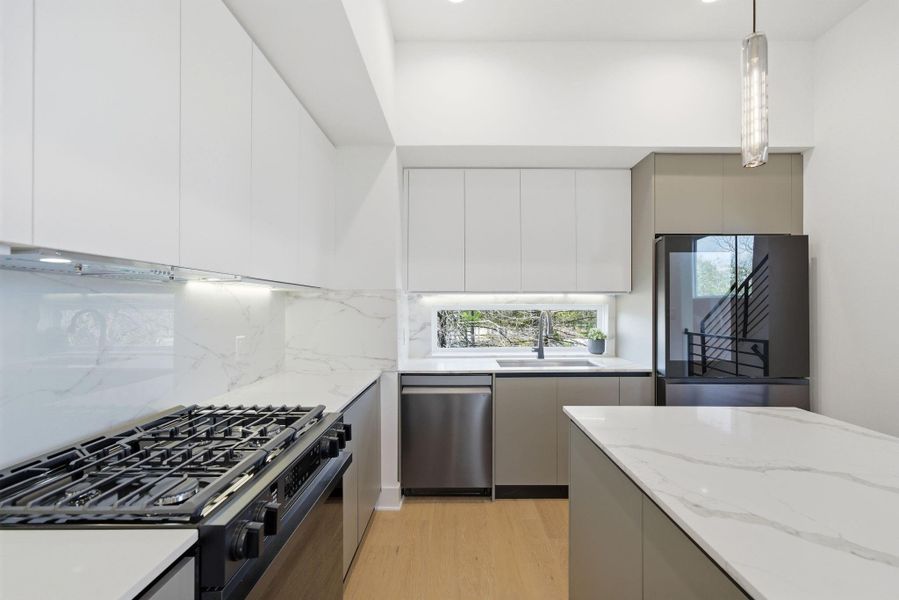 Gourmet kitchen with sleek cabinetry, spacious countertops, and premium appliances, enhanced by elegant under-cabinet lighting that highlights every detail. Gourmet kitchen with sleek cabinetry, spacious countertops, and premium appliances, enhanced by elegant under-cabinet lighting that highlights every detail.