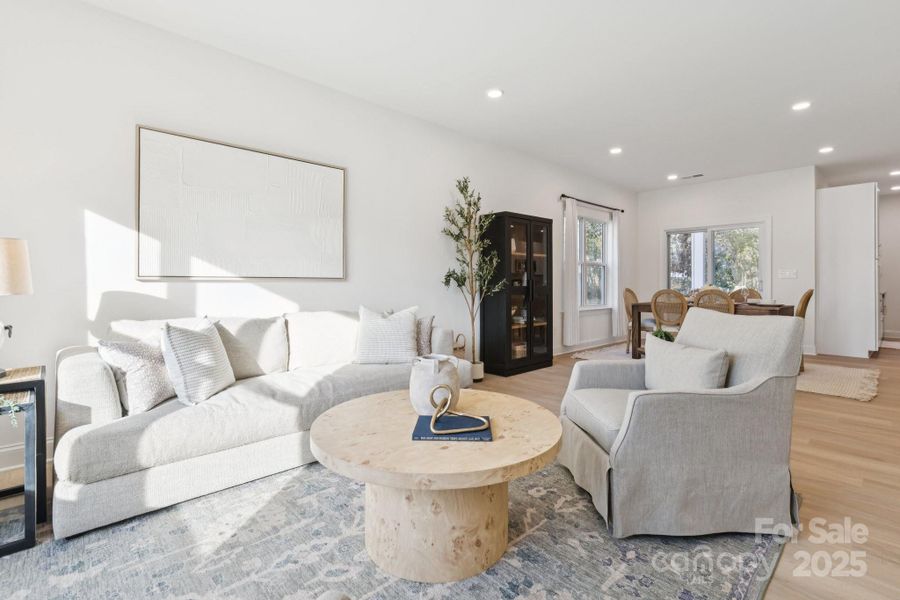 9' ceilings, light oak-colored LVP flooring, recessed lights, and tons of natural light fills this open-concept living space