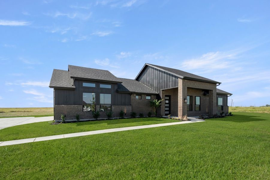 Front exterior of a new home in Carrera Ranch, Waxahachie, TX, highlighting curb appeal (Image 2). Front exterior of a new home in Carrera Ranch, Waxahachie, TX, highlighting curb appeal (Image 2).