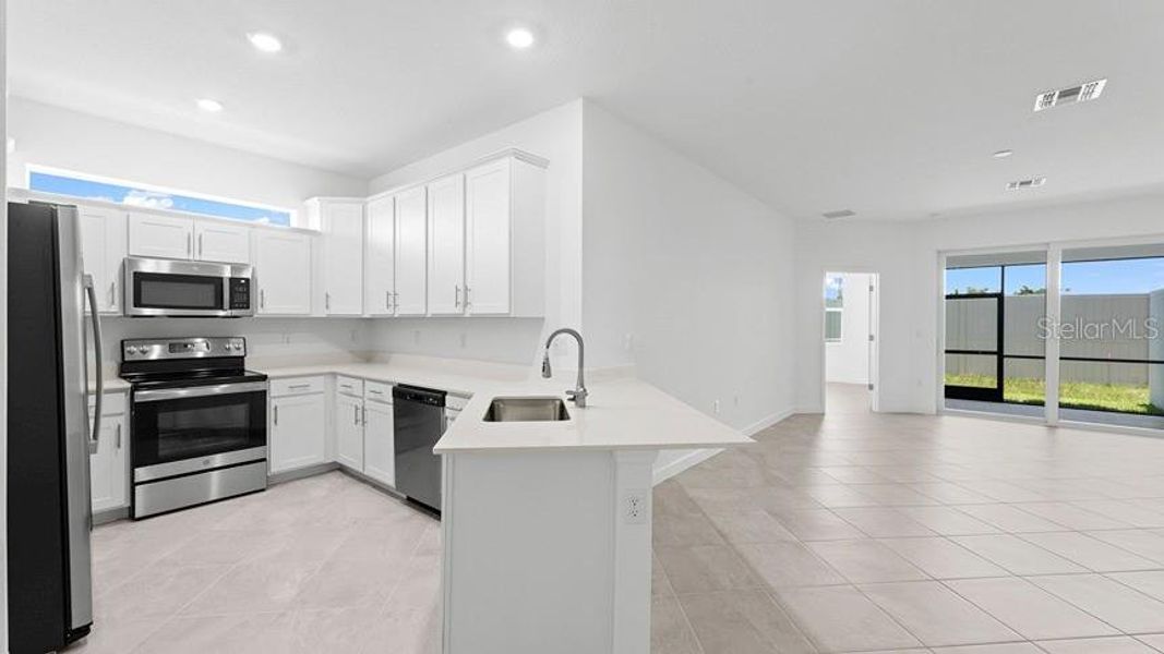 Furnished interior view inside a new home in Palm Lake at Coco Bay, Englewood (Image 5).