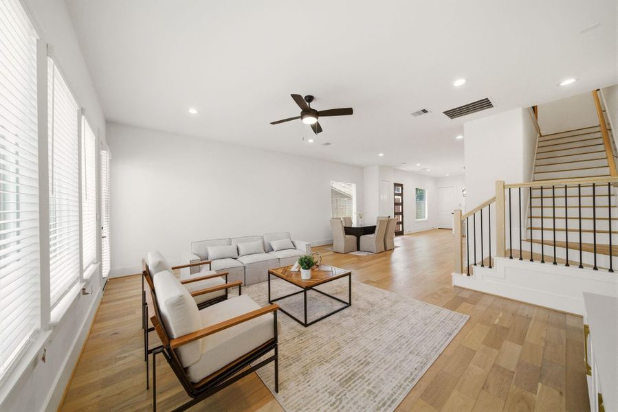 Wide-open first-floor living withelevated ceilings, natural light, anda thoughtfully designed flowthroughout the home. (Photo of a previous build, similar finishes.)