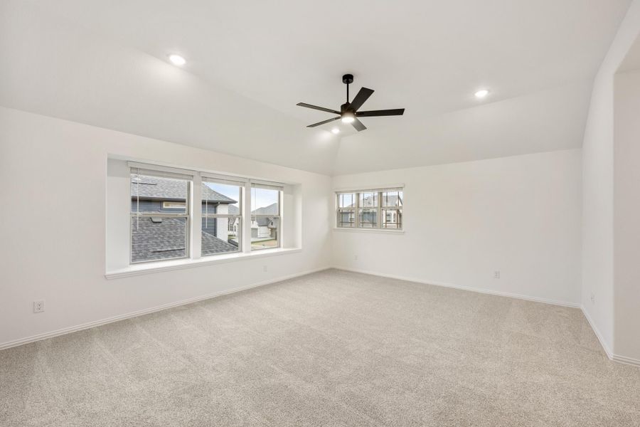 Empty bedroom with carpet flooring, ceiling fan, recessed lighting, and two windows with neighborhood views Empty bedroom with carpet flooring, ceiling fan, recessed lighting, and two windows with neighborhood views