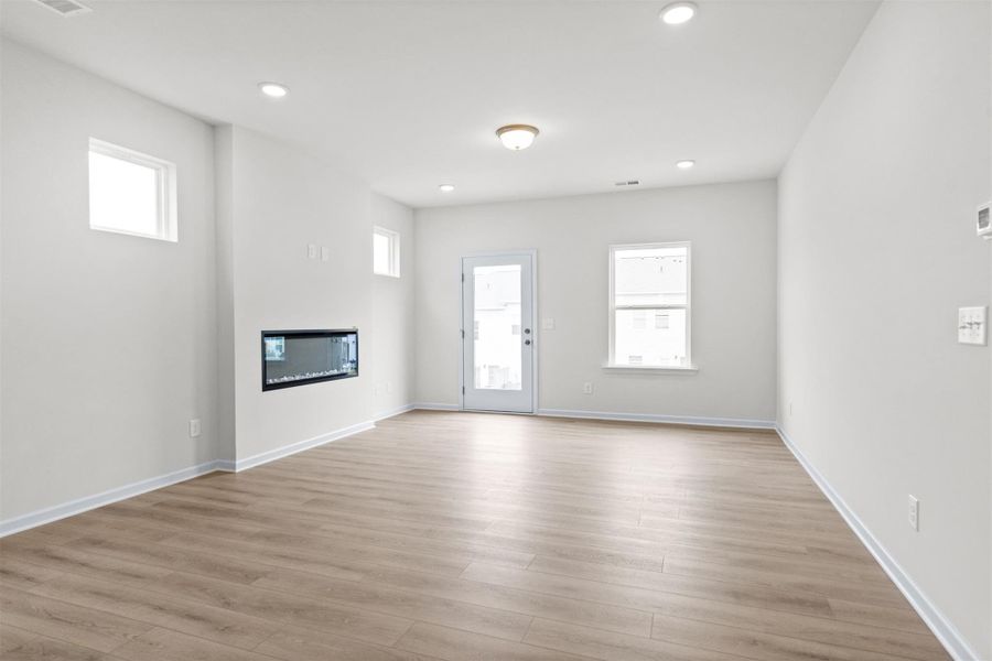 The Dove- Family Room with Linear Electric Fireplace. Home under construction, photo used for illustrative purposes only, colors and options will vary.