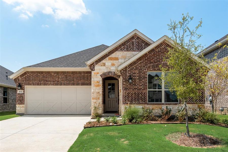 Front exterior of a new home in Spiritas Ranch, Little Elm, TX, highlighting curb appeal (Image 16). Front exterior of a new home in Spiritas Ranch, Little Elm, TX, highlighting curb appeal (Image 16).