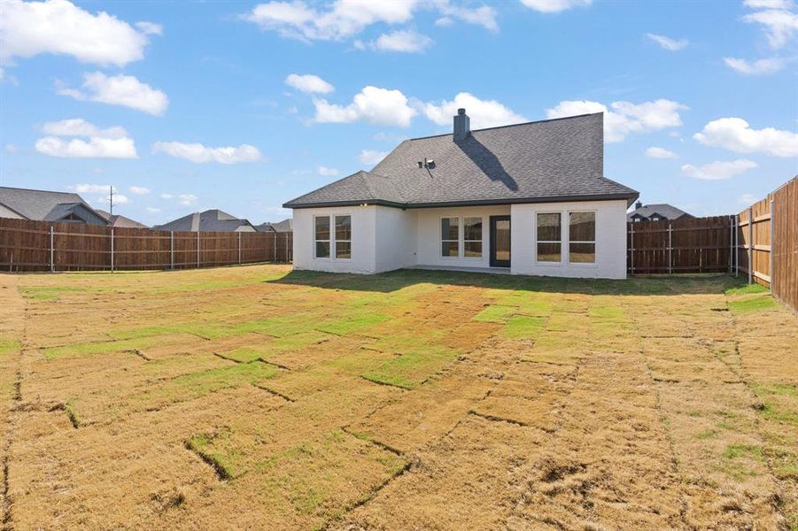 covered back patio, wooden privacy fence with metal poles