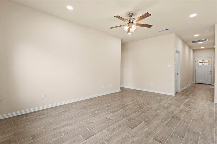 Spare room with baseboards, light wood finished floors, visible vents, and recessed lighting