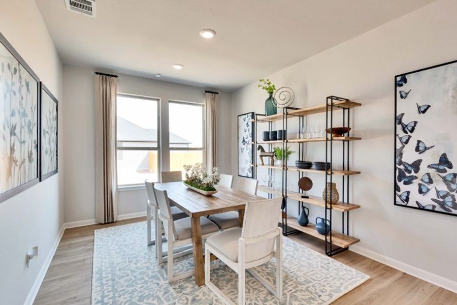 A dining room with a table and chairs. A dining room with a table and chairs.