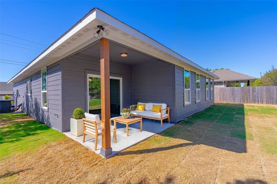 Rear view of house featuring a lawn and an outdoor hangout area