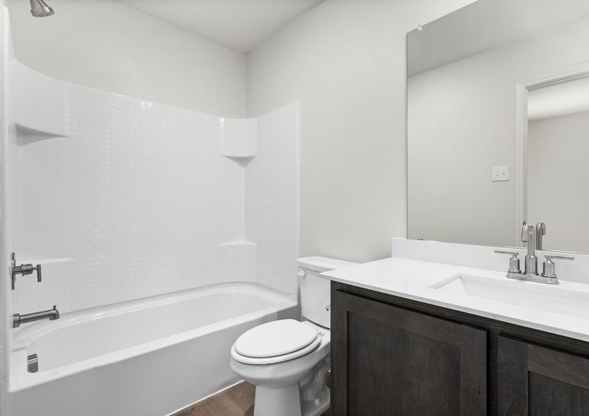 The secondary bathroom has a spacious vanity and shower-tub combo. The secondary bathroom has a spacious vanity and shower-tub combo.