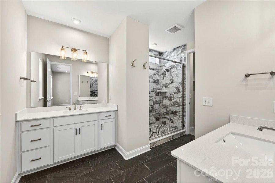 Dual vanity primary bathroom with ample storage Dual vanity primary bathroom with ample storage