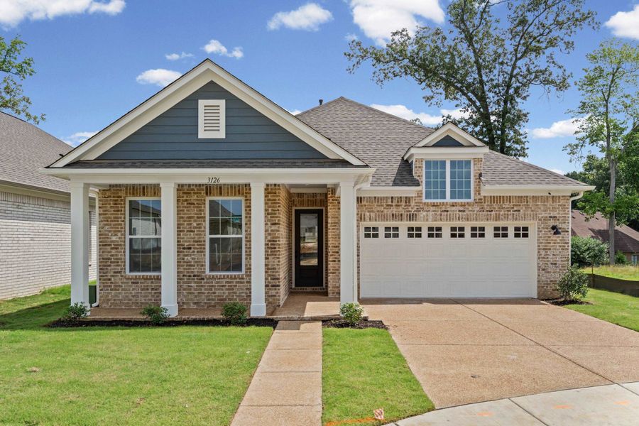 Brick facade with accent siding, covered front porch, attached garage, concrete driveway, and dormer window Brick facade with accent siding, covered front porch, attached garage, concrete driveway, and dormer window