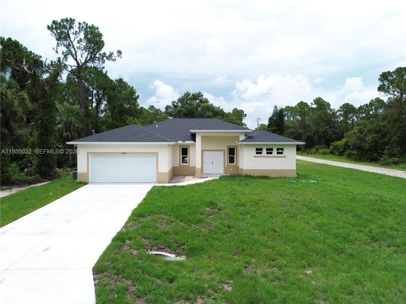 Front exterior of a new home in , Lehigh Acres, FL, highlighting curb appeal (Image 27).