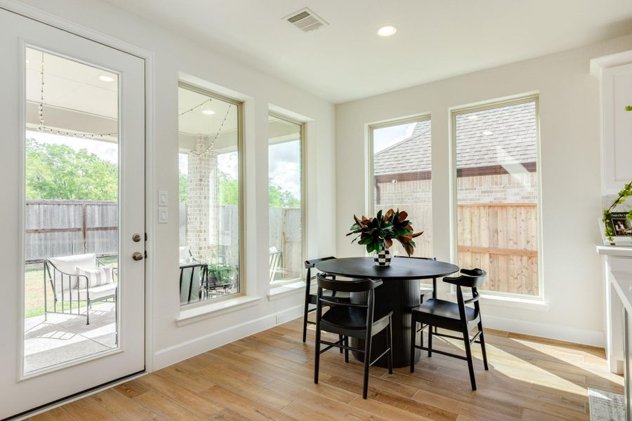 Sun-drenched breakfast nook featuring dual-aspect windows that fill the space with natural light, creating a bright and cozy atmosphere. Sun-drenched breakfast nook featuring dual-aspect windows that fill the space with natural light, creating a bright and cozy atmosphere.