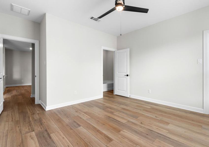 Windows let in plenty of natural light to this master bedroom.