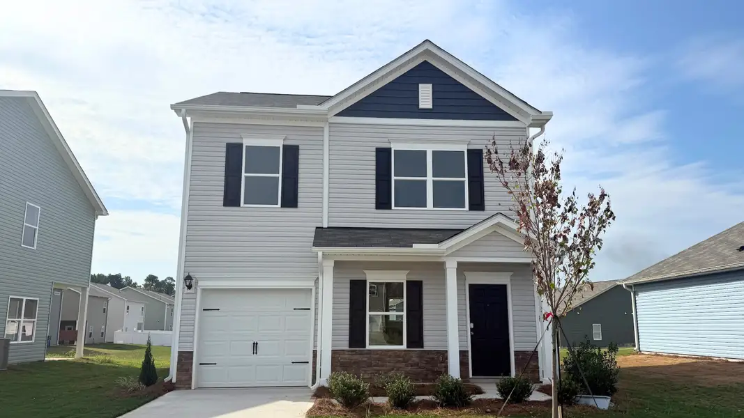 Front exterior of a new home in Avery Chase, Dunn, NC, highlighting curb appeal (Image 1). Front exterior of a new home in Avery Chase, Dunn, NC, highlighting curb appeal (Image 1).