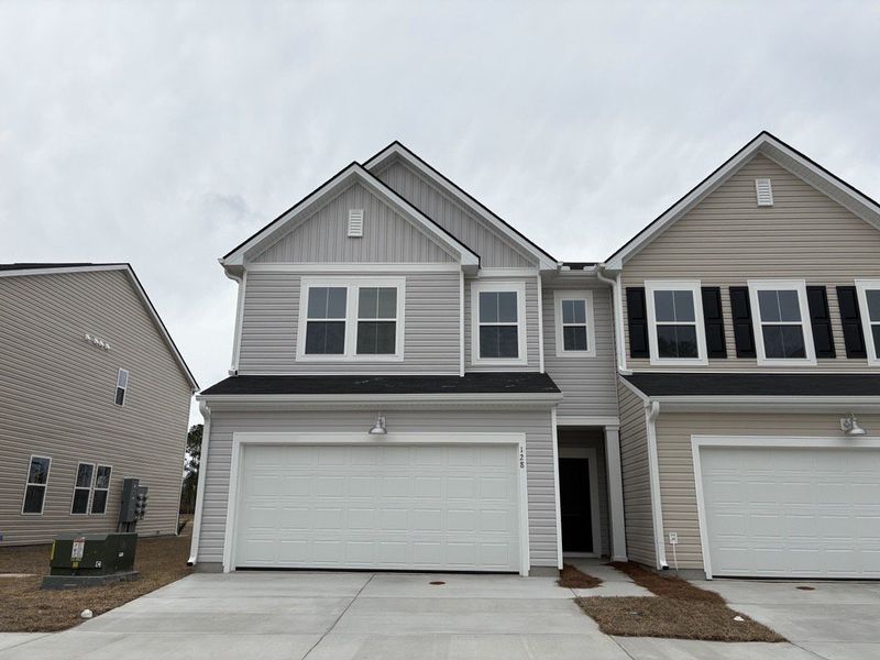 Front exterior of a new home in Dawson Pointe, Summerville, SC, highlighting curb appeal (Image 1). Front exterior of a new home in Dawson Pointe, Summerville, SC, highlighting curb appeal (Image 1).