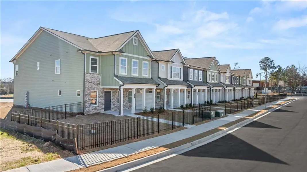 Front exterior of a new home in Lake Carlton, Loganville, GA, highlighting curb appeal (Image 2). Front exterior of a new home in Lake Carlton, Loganville, GA, highlighting curb appeal (Image 2).