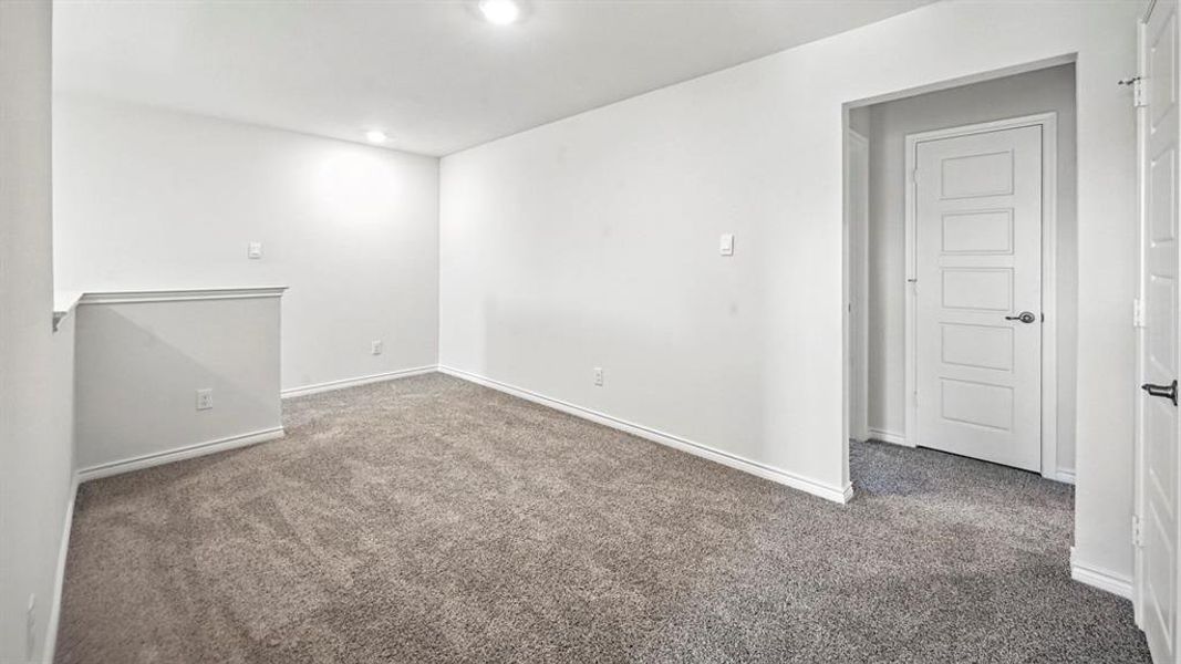 Empty room featuring carpet flooring and baseboards Empty room featuring carpet flooring and baseboards