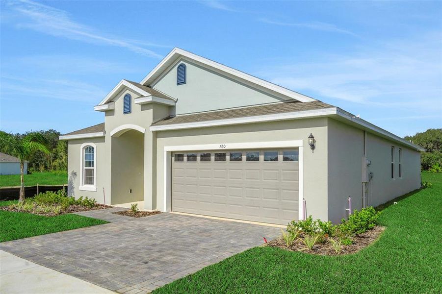 Front exterior of a new home in Reserve at Hammock Oaks, Lady Lake, FL, highlighting curb appeal (Image 21).