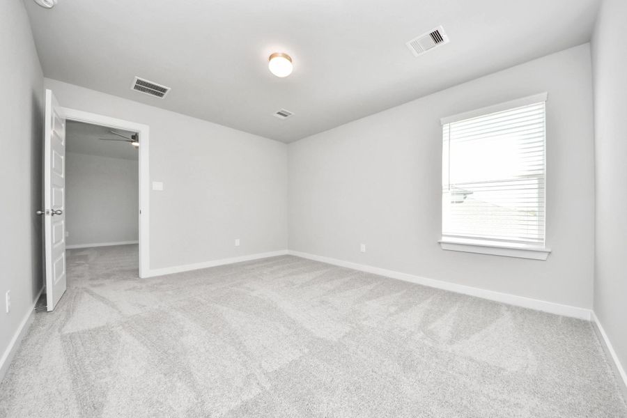 Generously sized secondary bedrooms featuring spacious closets, soft and inviting carpeting underfoot, large windows allowing plenty of natural light, and the added touch of privacy blinds for your personal retreat. Sample photo of completed home with similar floor plan. Actual colors and selections may vary.