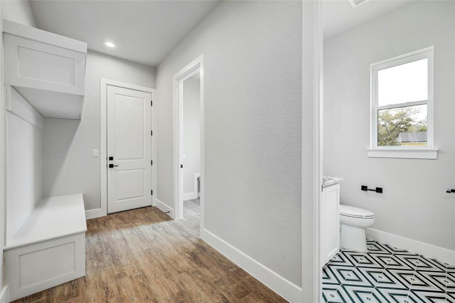 Mudroom with recessed lighting, baseboards, and wood finished floors