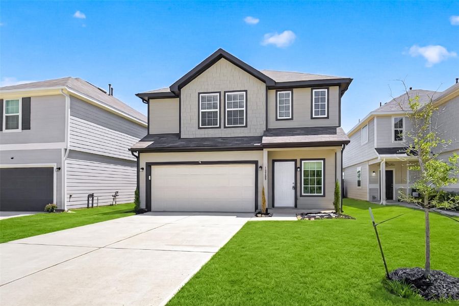 Front exterior of a new home in River's Edge, Conroe, TX, highlighting curb appeal (Image 22). Front exterior of a new home in River's Edge, Conroe, TX, highlighting curb appeal (Image 22).