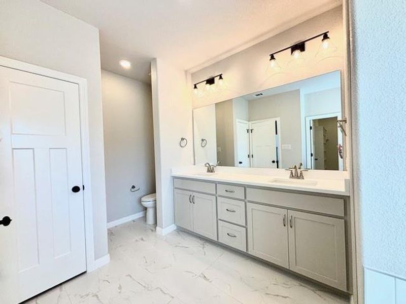 Bathroom featuring vanity and toilet