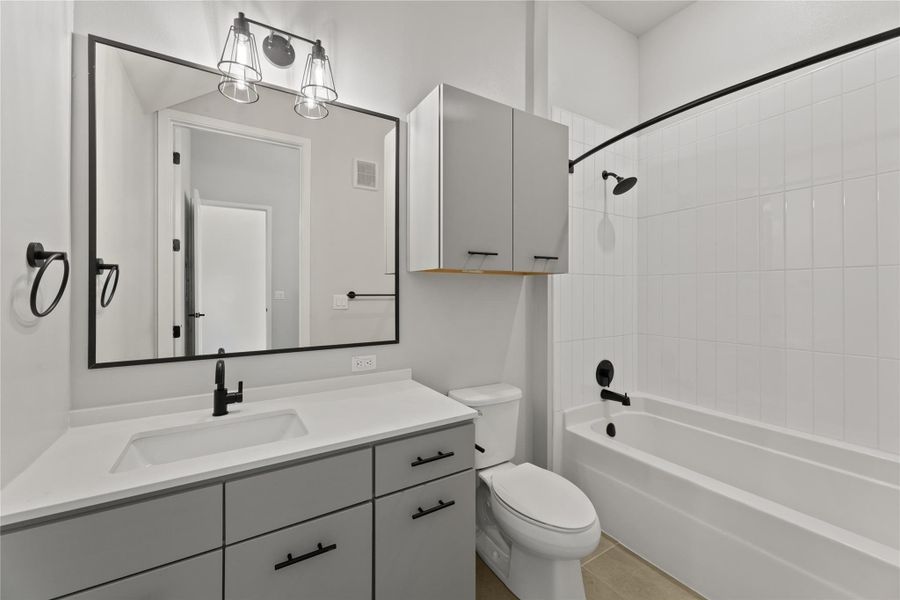Bathroom with vanity and tub / shower combination