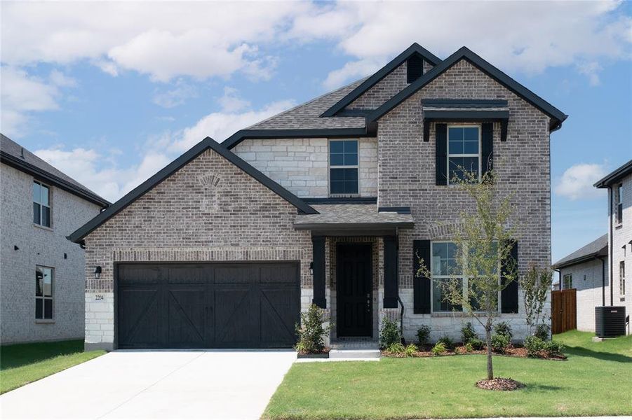 Front exterior of a new home in Valencia on the Lake: Valencia 50s, Little Elm, TX, highlighting curb appeal (Image 12). Front exterior of a new home in Valencia on the Lake: Valencia 50s, Little Elm, TX, highlighting curb appeal (Image 12).