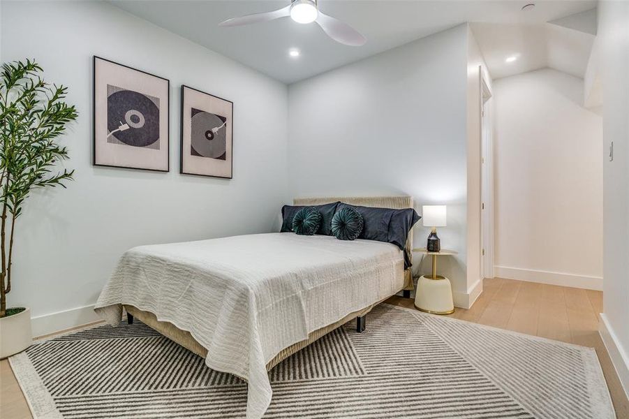 Model Home scondary Bedroom with a ceiling fan, recessed lighting, and light wood-style flooring
