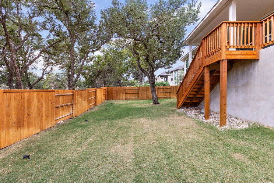 Fenced backyard featuring stairway and a wooden deck