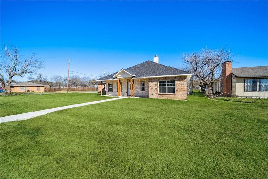 Ranch-style home featuring a front yard