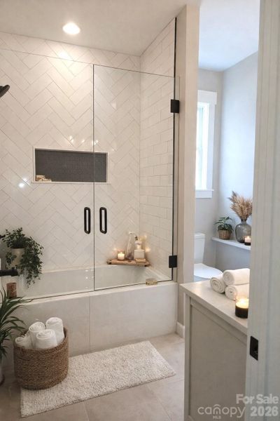 Full Bath 2 with herringbone tile & double vanities.
