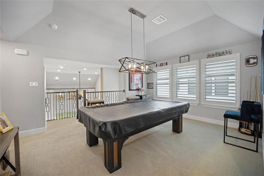 Rec room featuring light carpet, vaulted ceiling, and pool table