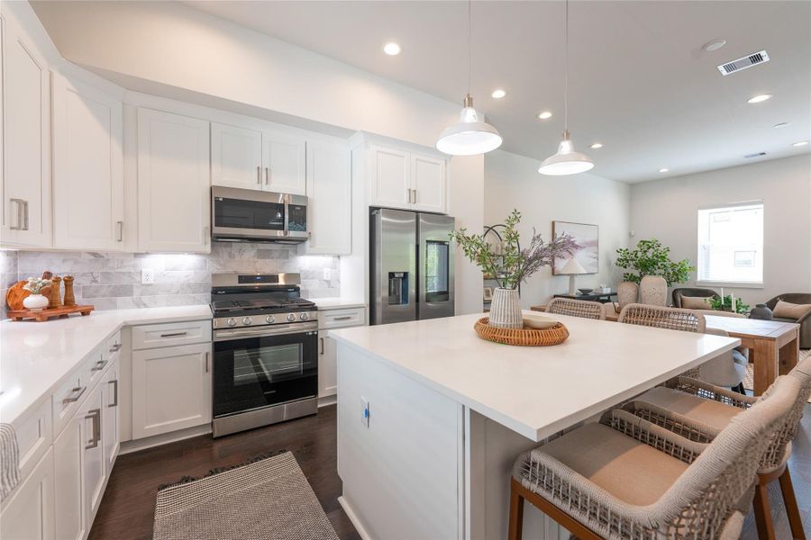 Gourmet kitchen with quartz countertops and center island