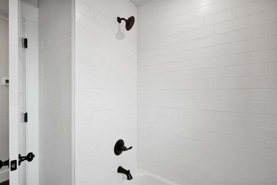 Room details with tiled shower / bath