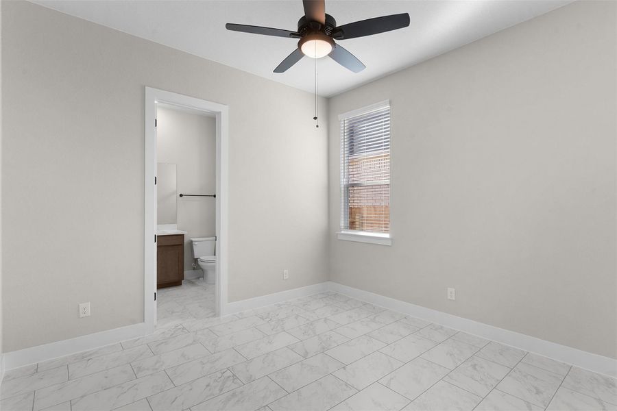 Unfurnished bedroom with a ceiling fan, ensuite bath, and light marble finish floors