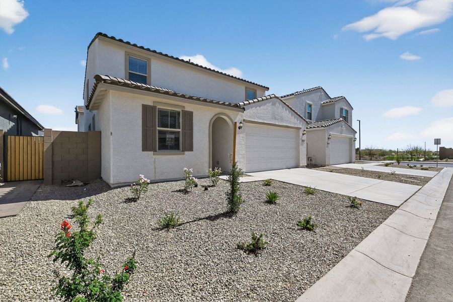 Front exterior of a new home in Artisan at Asante, Surprise, AZ, highlighting curb appeal (Image 2). Front exterior of a new home in Artisan at Asante, Surprise, AZ, highlighting curb appeal (Image 2).