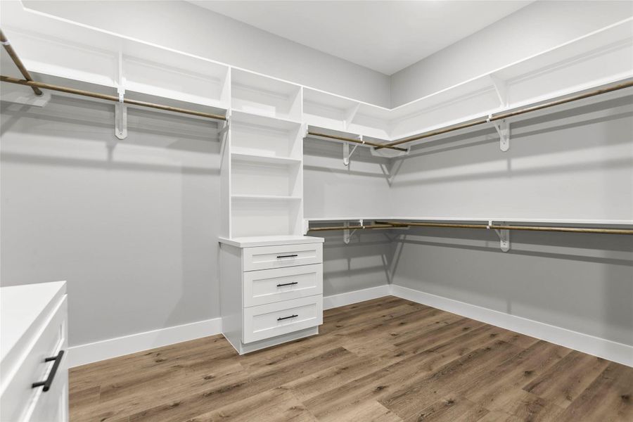 The oversized primary closet with built in storage and plenty of space for any clothes horse. The oversized primary closet with built in storage and plenty of space for any clothes horse.